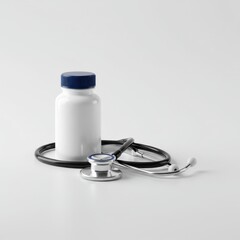Healthcare and Medicine: Stethoscope and Medicine Bottle on White Background