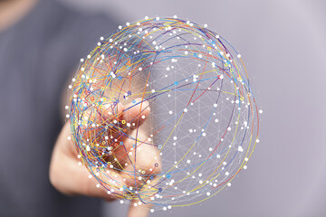 Image depicting a hand interacting with a digital globe, symbolizing global network and interconnectedness.