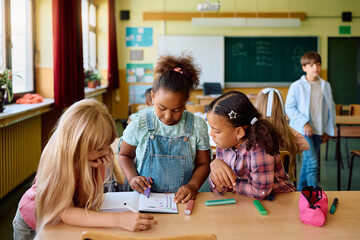 Group of girls learning together in classroom at elementary school.