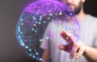 A man interacts with a digital globe, showcasing global network connections and data visualization.