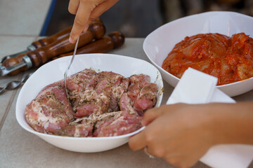 Outdoor Kitchen Preparation: Seasoning Minced Meat with Spices, Rustic Bowls, Grilling Tools, Pink...