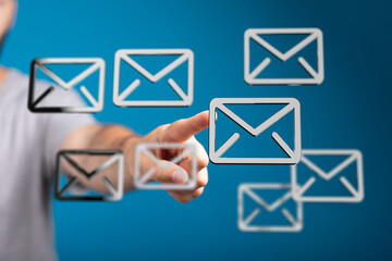 Person interacting with email icons, digital communication concept.