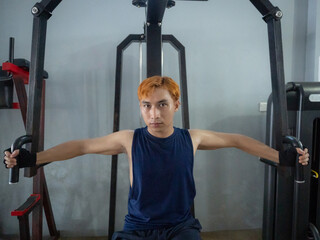 Asian men use gym equipment to do tricep, chest, arm exercises, focusing on building strength and...