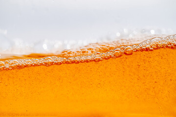 Close up bright orange Oil or beer splash texture and nature waves, Beautiful waves curve and...