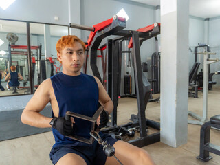 Asian men use gym equipment to do tricep, chest, arm exercises, focusing on building strength and...