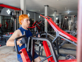 Asian men use gym equipment to do tricep, chest, arm exercises, focusing on building strength and...