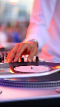 DJ spinning vinyl records on the turntable to make music for the party