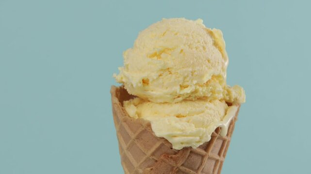 zoom yellow gelato scoop in waffer coner blue background