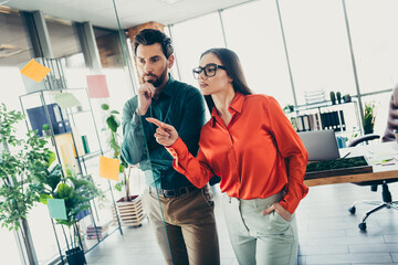 Business professionals discussing ideas during a brainstorming session in a modern collaborative office workspace setting