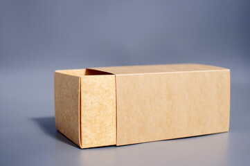 Simple open brown cardboard box on gray surface
