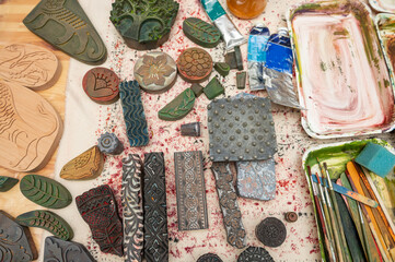 Handcrafted block printing tools and paints in artistic workspace