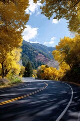 Scenic mountain road lined with fall-colored trees, crisp light