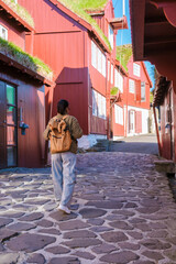 Exploring the charming red buildings of Torshavn in the Faroe Islands on a sunny day