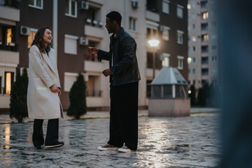 Friends enjoying an engaging conversation in an urban setting near apartment buildings, highlighted...