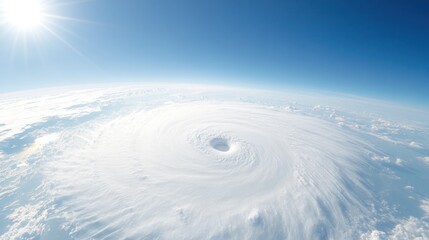 Aerial view of a powerful hurricane swirling in the open ocean, showcasing nature's immense force and beauty against a clear blue sky.