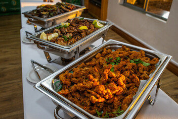 Crumbed chicken in a metal dish at a buffet station