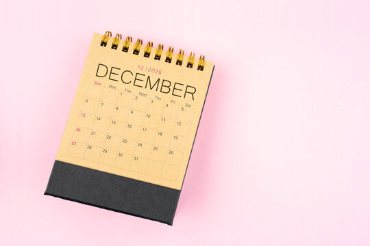 Brown calendar for December 2026 on pink background, Flat lay. Planning concept.
