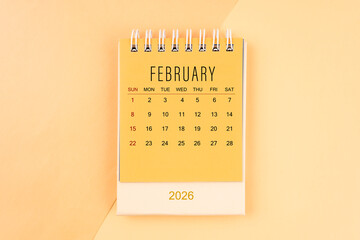 February 2026 mini desk calendar on the yellow, planning for business meeting concept.