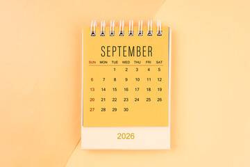 September 2026 mini desk calendar on the yellow, planning for business meeting concept.
