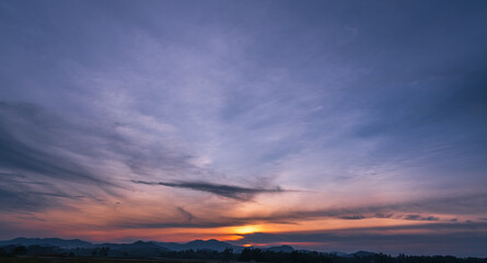 Dusk Sky, Evening sky on twilight Dark Blue Hour after sun down, Horizon landscape over silhouette mountains countryside with Purple , Red, Orange sunset sunlight and Dramatic clouds in summer season