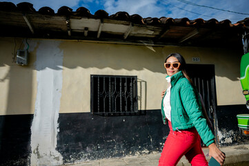 Young latin woman walking down the street