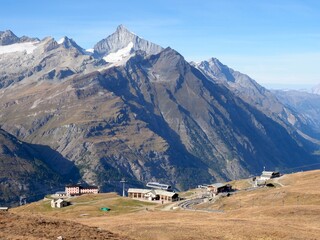 Alpine Mountain Station with Panoramic View of Snow-Capped Peaks in the Swiss Alps