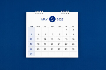 May 2026 Monthly desk calendar on navy blue color leather background.
