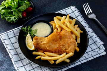 Fish and Chips: Classic British meal of crispy battered fish served with golden fries and tartar...