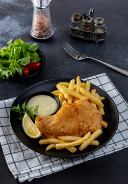 Fish and Chips: Classic British meal of crispy battered fish served with golden fries and tartar sauce.