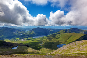 A panoramic view of the mountains and lakes of North Wales. Summer day with low clouds and the lush...