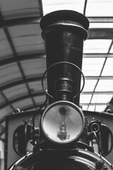 Historic steam locomotive with intricate details standing proudly in a vintage railway museum during a sunny afternoon