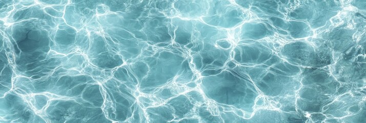 Clear blue water surface with sunlight reflections creating dynamic, wavy patterns.