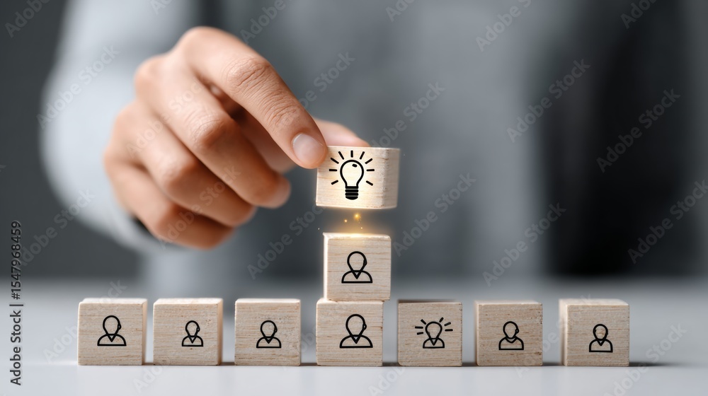 Aufkleber person is holding a block with a light bulb on it, and it is on top of a stack of blocks. the image 