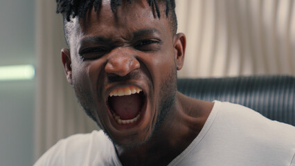 Futurism African American ethnic man male guy in white futuristic room indoors cyberspace modern technology scream shout yell angry mad crazy aggressive problem screaming shouting yelling annoyed