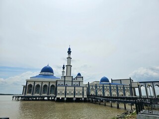 Floating on a sea of tranquility, this mosque is a sight to behold.  The perfect blend of architecture and nature.