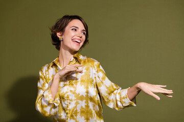Young businesswoman in khaki setting enjoying a lighthearted moment while wearing stylish casual...