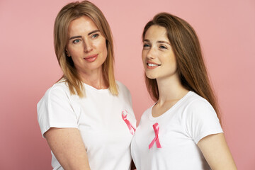 Women wearing pink ribbon showing support for breast cancer awareness