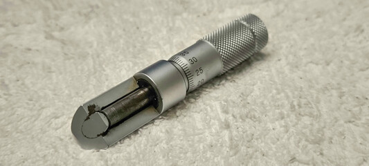 High-resolution thickness micrometer placed on white cloth
