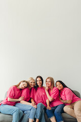 Diverse women embracing and showing support for breast cancer awareness