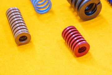 The mold and die spring  standard spare parts on the yellow back ground.
