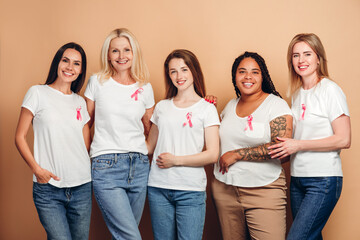 Group of multinational women of different ages and ethnicities supporting breast cancer awareness