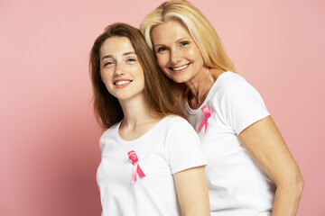 Women wearing pink ribbons showing support for breast cancer awareness