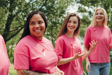 Diverse women smiling and supporting breast cancer awareness month