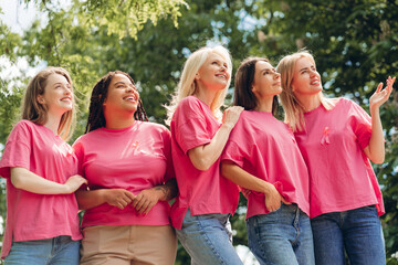 Diverse women wearing pink supporting breast cancer awareness