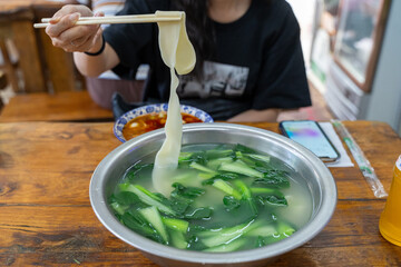 Large bowl of soup with chopsticks