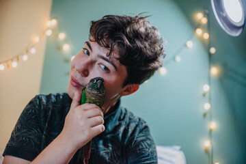 A young girl joyfully embraces her green parrot, capturing a warm moment of affection. The cozy...