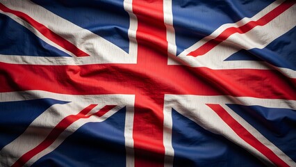 A textured Union Jack flag, dramatically draped, showcasing the vibrant red, white, and blue. Its folds and creases add depth and a sense of history and national pride.