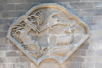 Stone carving of nature scene with animals