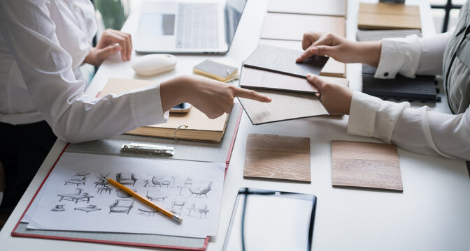 Interior designer presenting eco friendly wooden material samples for sustainable home decor