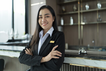 Beautiful asian hotel receptionist in  uniforms at desk in lobby Friendly and welcome staff in...